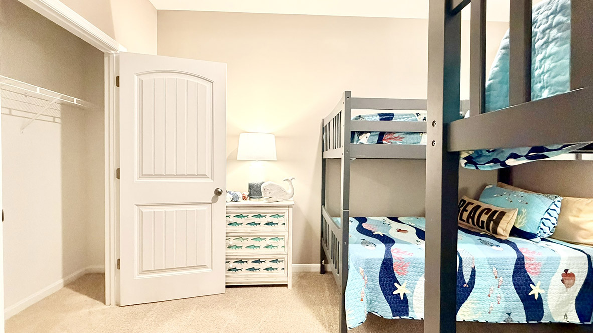 Continuing down the hall is a guest bedroom with a large closet.