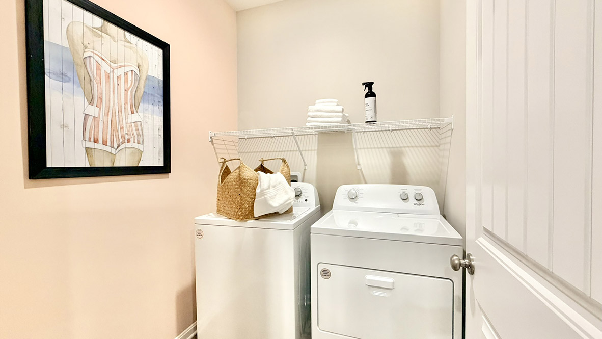 The laundry room is located near the guest bedrooms.