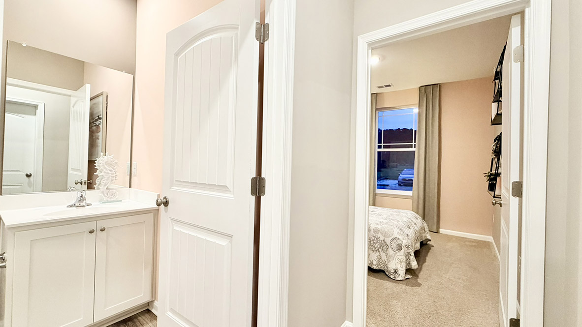 Continuing down the hall is another guest bedroom and a full bathroom.