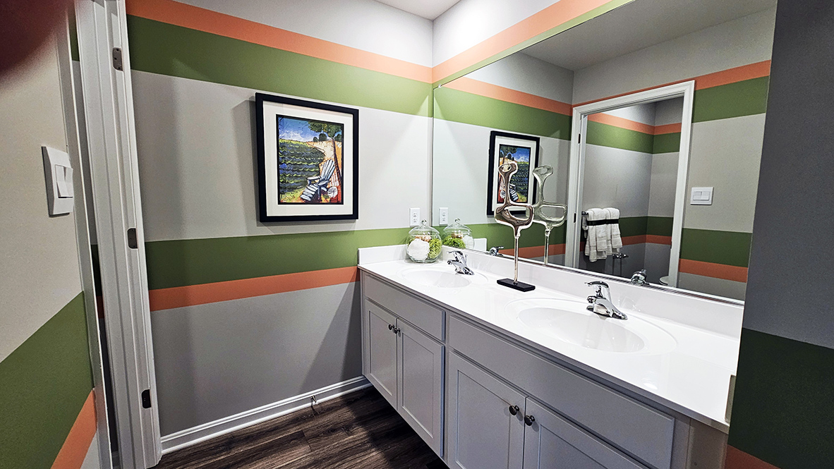 Upstairs, there is a guest bathroom with a double bowl vanity.