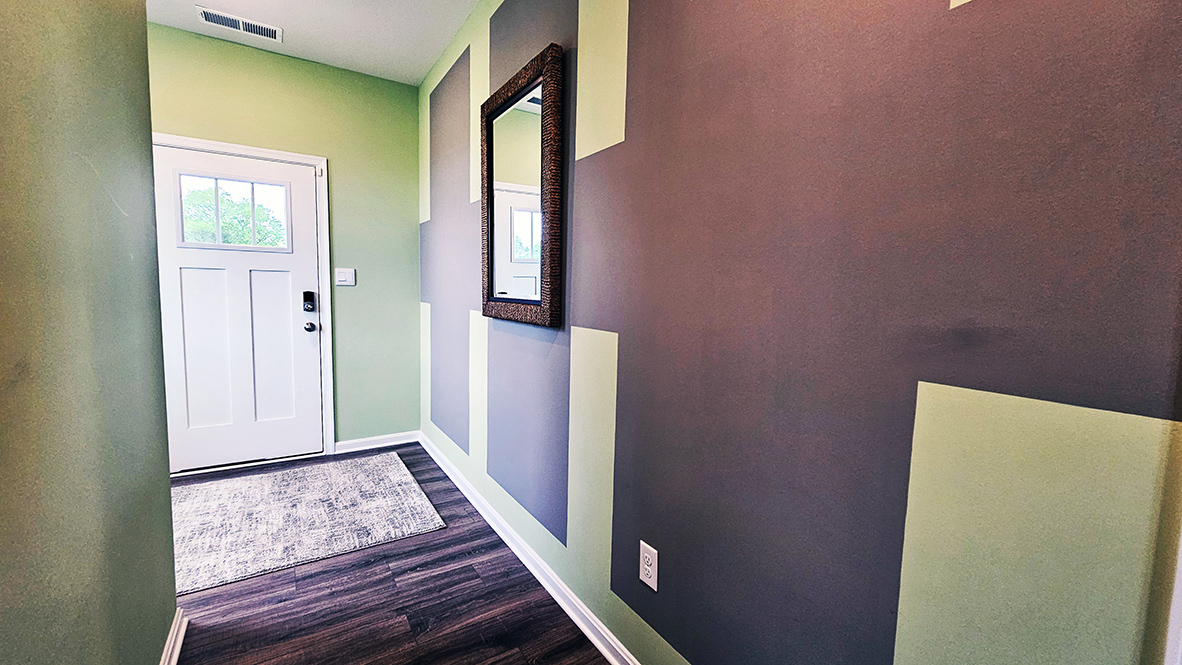 The inviting foyer offers a convenient powder room, coat closet, and easy access to the garage.