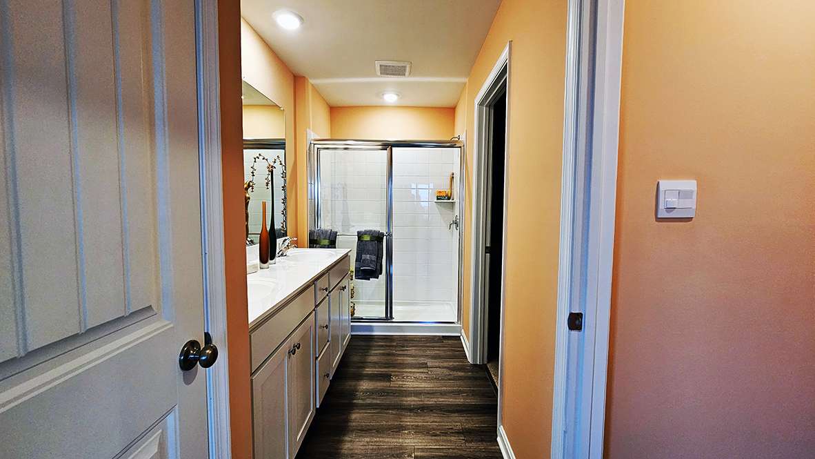 The modern bathroom has a double vanity and generously sized shower.