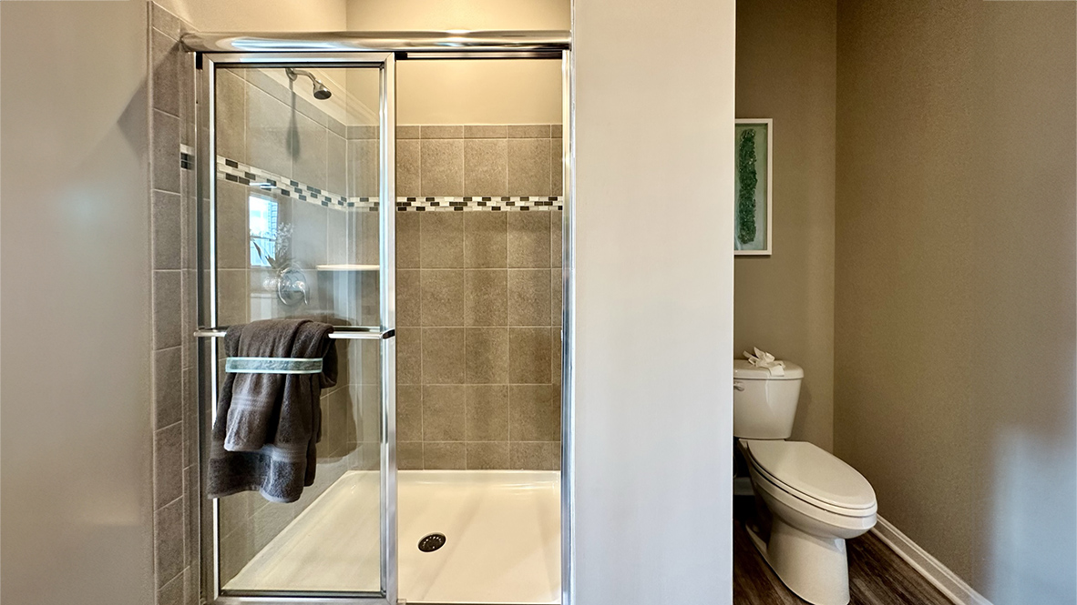 The inviting bathroom has a generously sized shower.