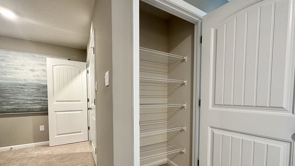 The tucked-away stairs lead you to a landing area where you will find a linen closet.
