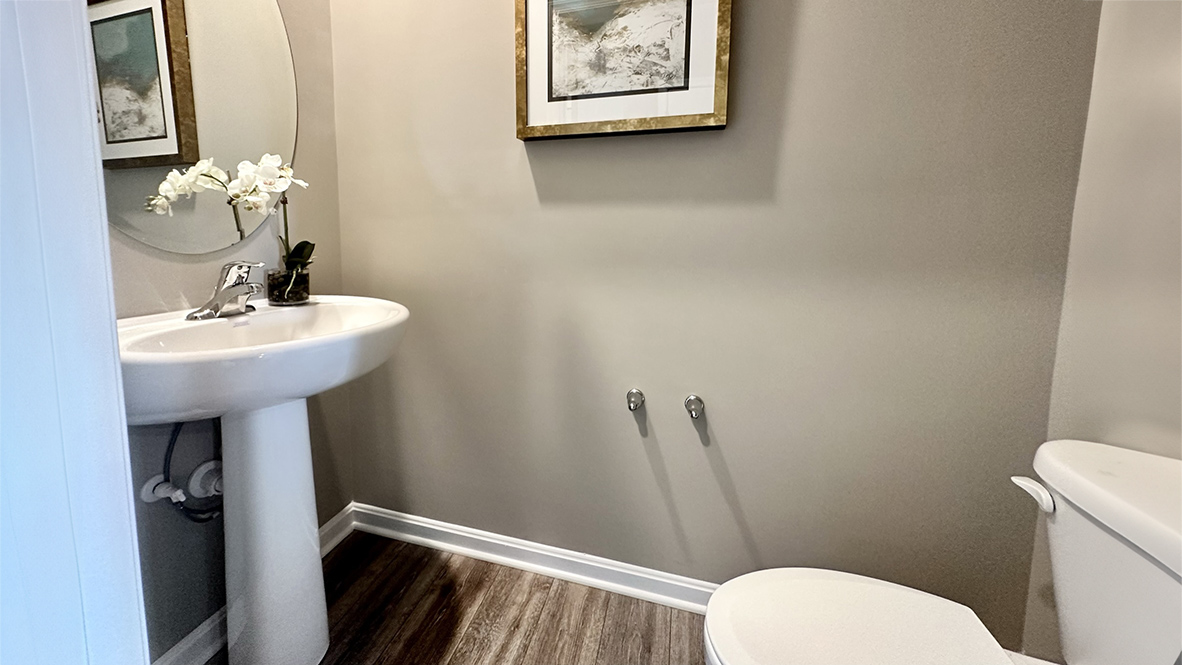 The inviting foyer features a coat closet and access to the conveniently located powder room.