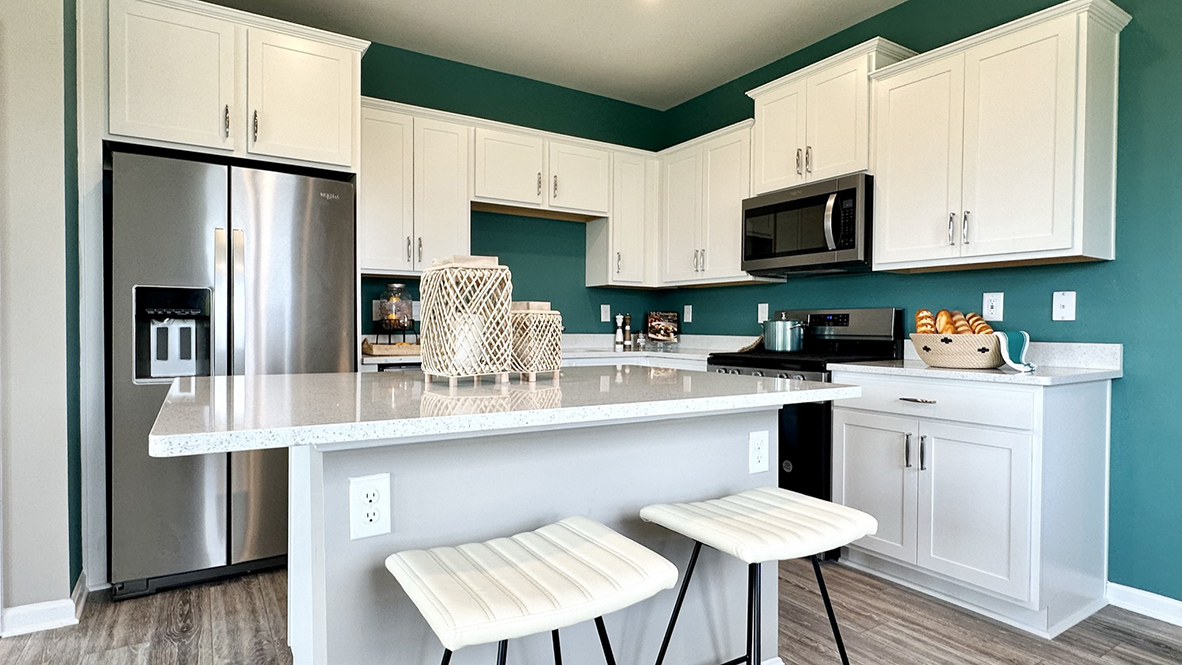The home’s well-designed eat-in kitchen boasts a center island with room for seating.