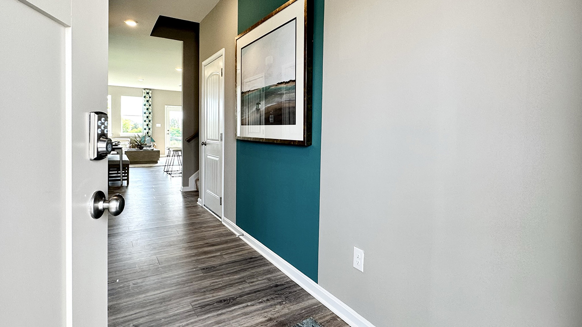 The inviting foyer features a coat closet and access to the conveniently located powder room.