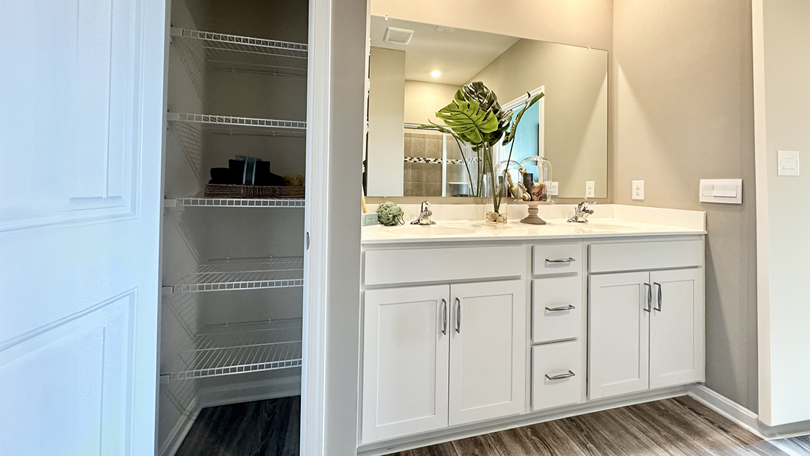 The inviting bathroom has a double bowl vanity.
