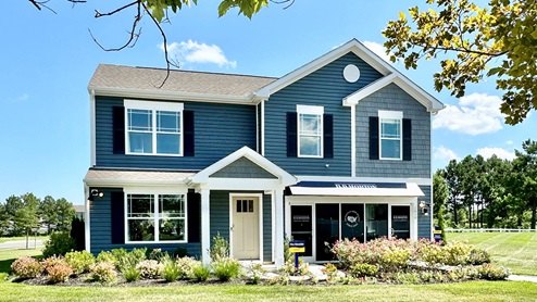 Blackwater Landing model home with blue siding and a two-car garage.