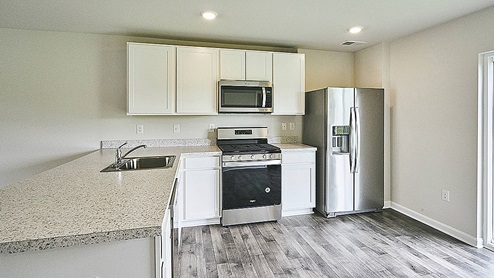 Kitchen with white cabinets and stainless steel appliances.