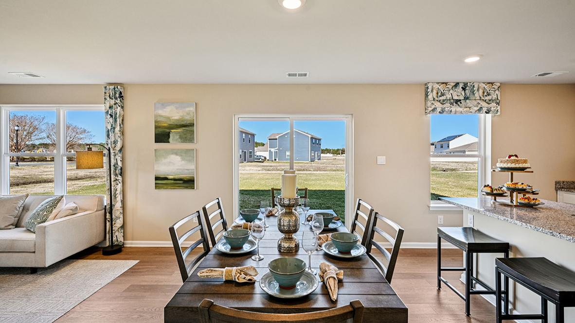 Dining area that overlooks sliding glass door to backyard.