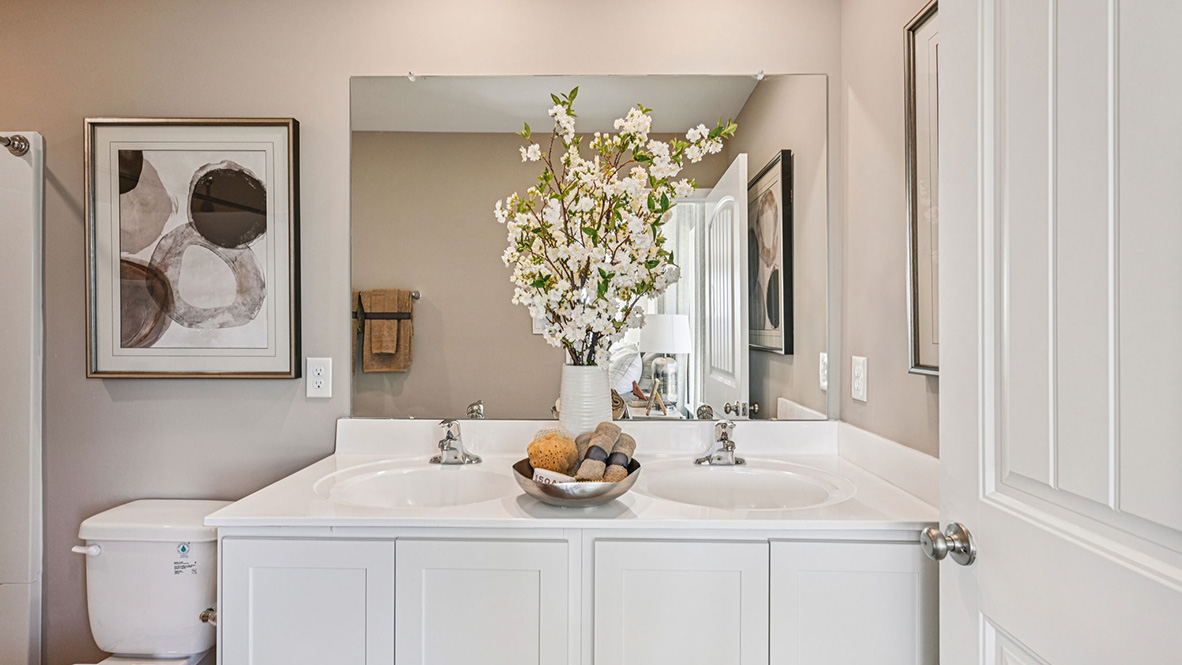 The modern main bathroom has a double bowl vanity.