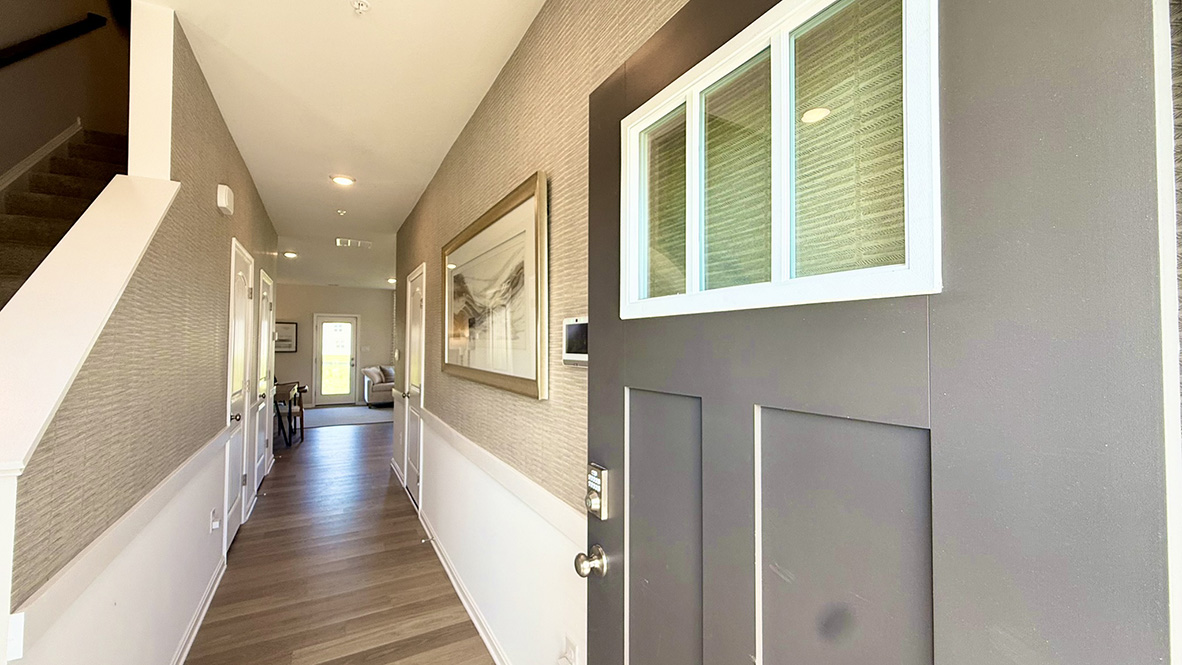 As you enter from the front porch, the inviting foyer leads you to a long hallway.