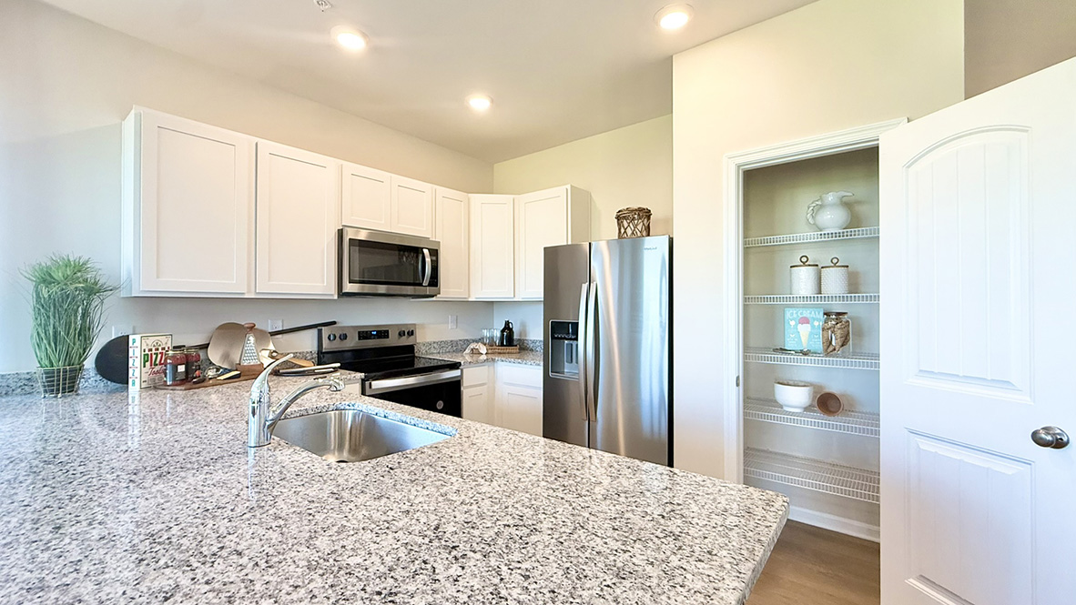 The home's functional eat-in kitchen features granite countertops.