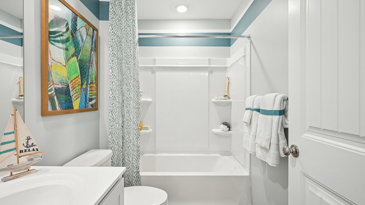 Secondary bathroom with shower, toilet and vanity.