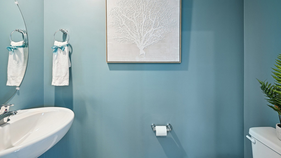 The powder room is tucked off the kitchen.