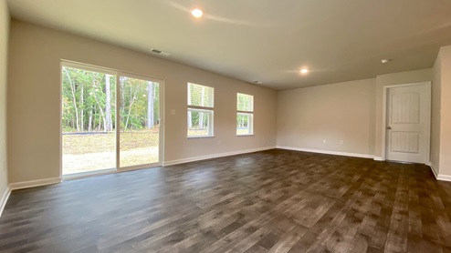 Open floorplan with sliding glass door.