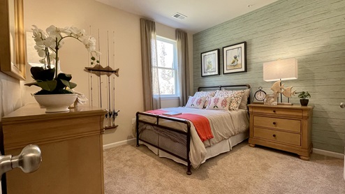 First floor guest bedroom showcased in the Hayden home.