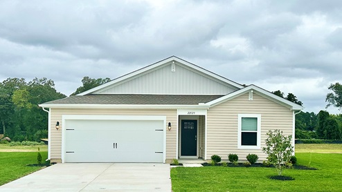 Exterior of Neuville ranch home with sand colored siding.