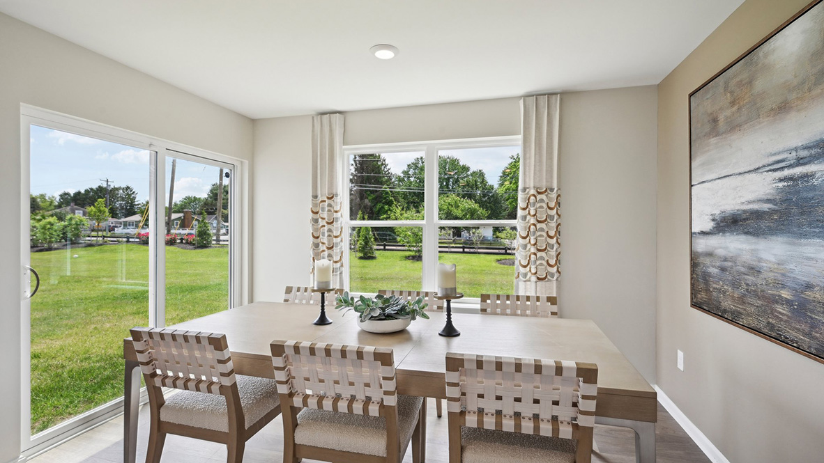 The kitchen has a designated dining area with a sliding glass door for easy access to the backyard.