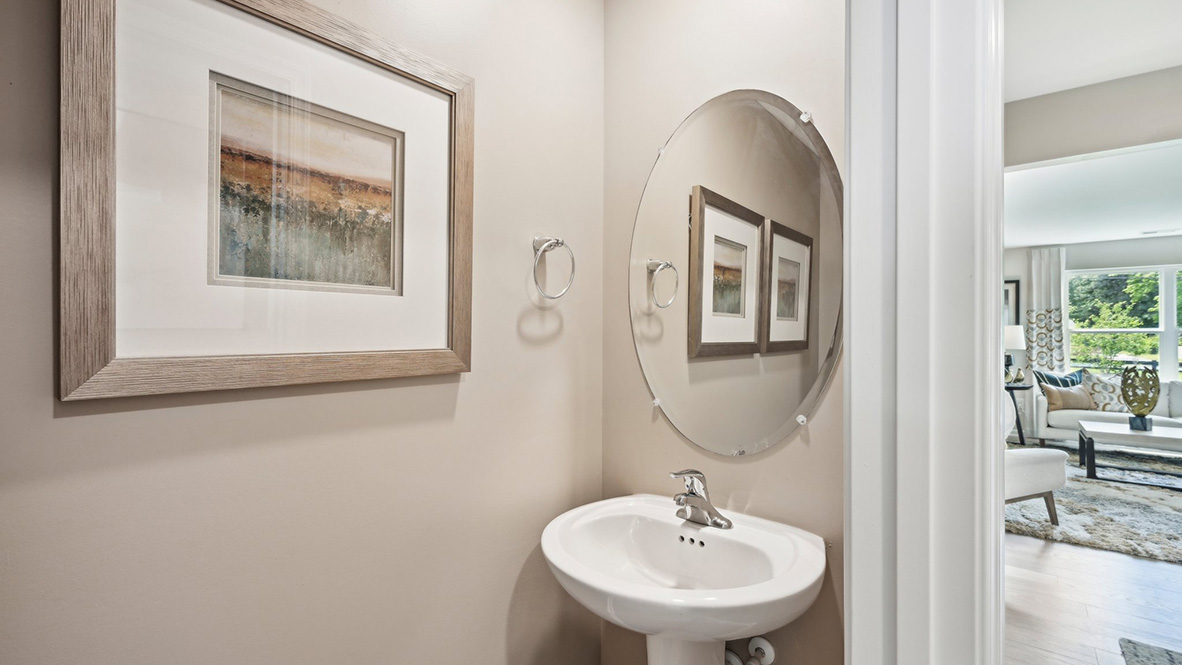 A powder room greets you as you enter this home from the porch.