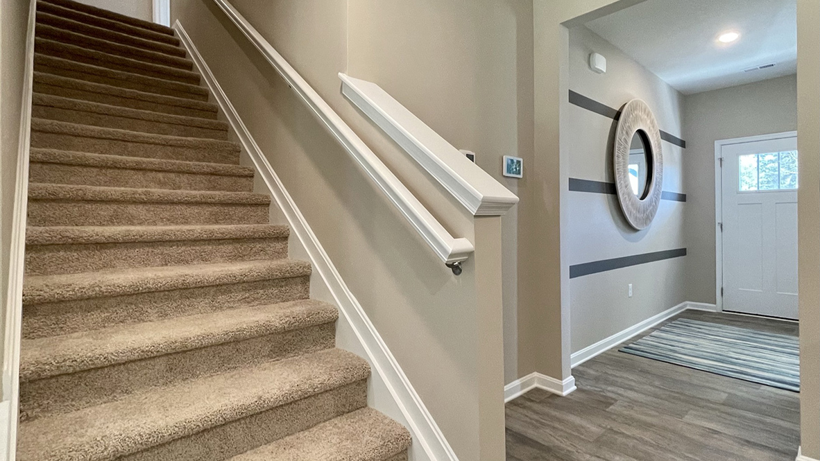 The stairway to upstairs is near the foyer.