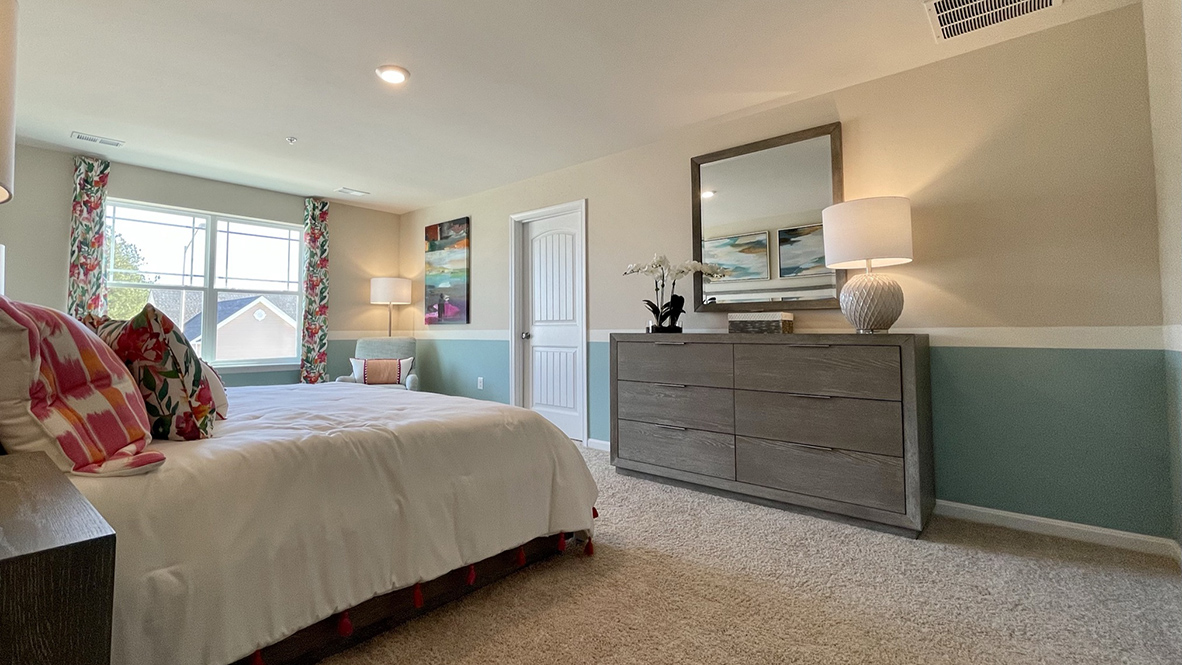 This primary bedroom has a large double window.