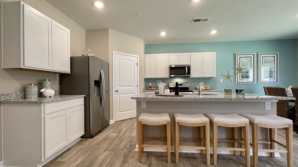 The spacious kitchen has a large island with upgraded countertops.