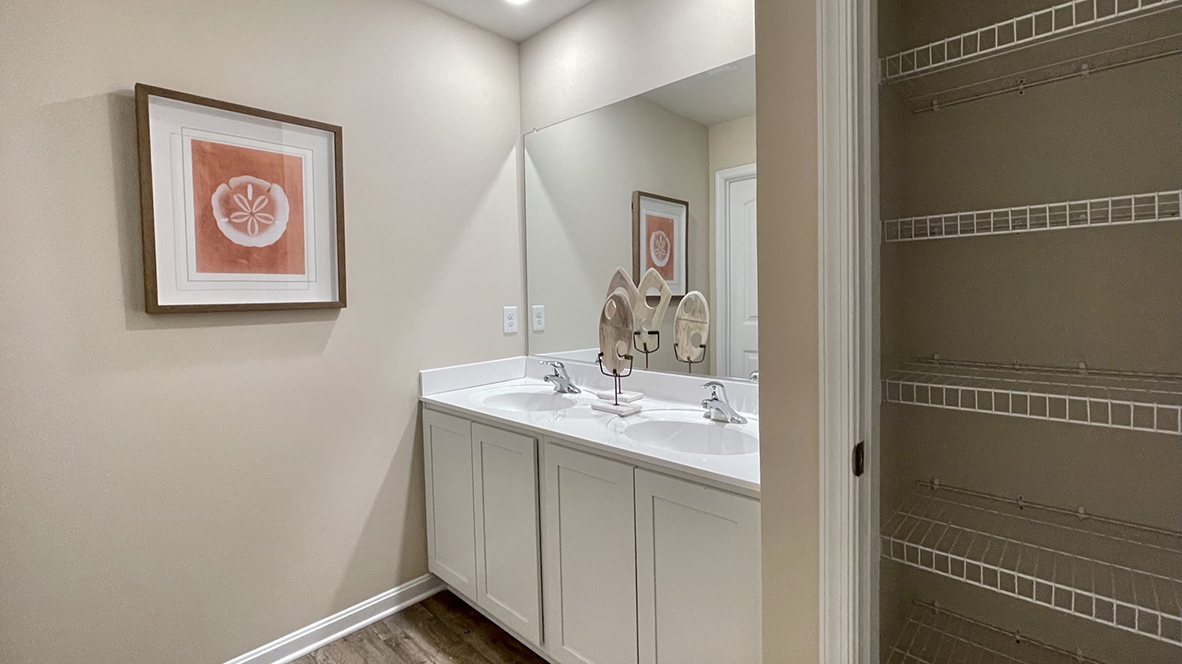 A shared hallway bathroom with extra linen closet.