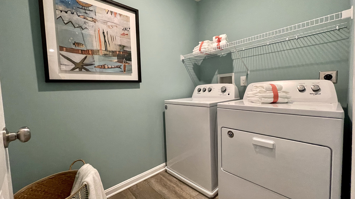 The laundry room includes a washer and dryer