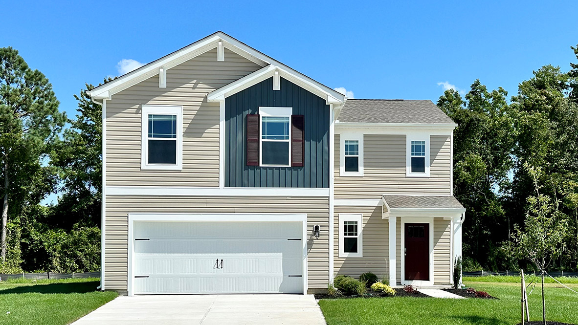 A two-story Deerfield home with tan siding and blue accents.