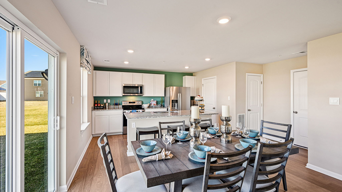The kitchen has laminate plank flooring.