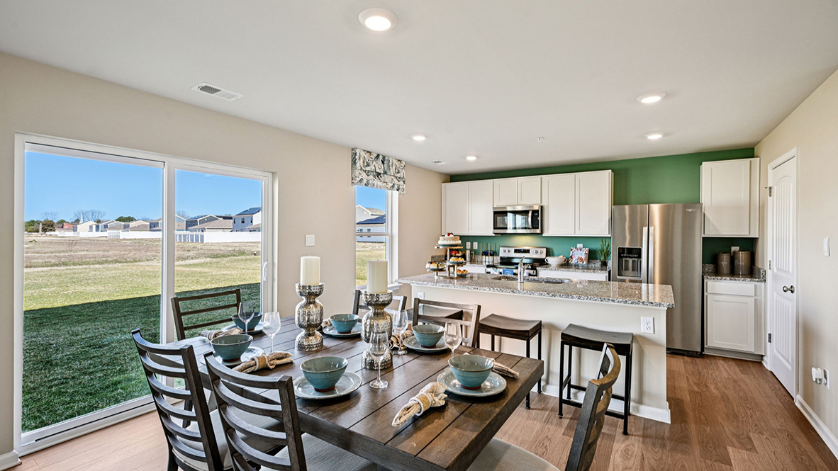 Dining area that overlooks sliding glass door to backyard.