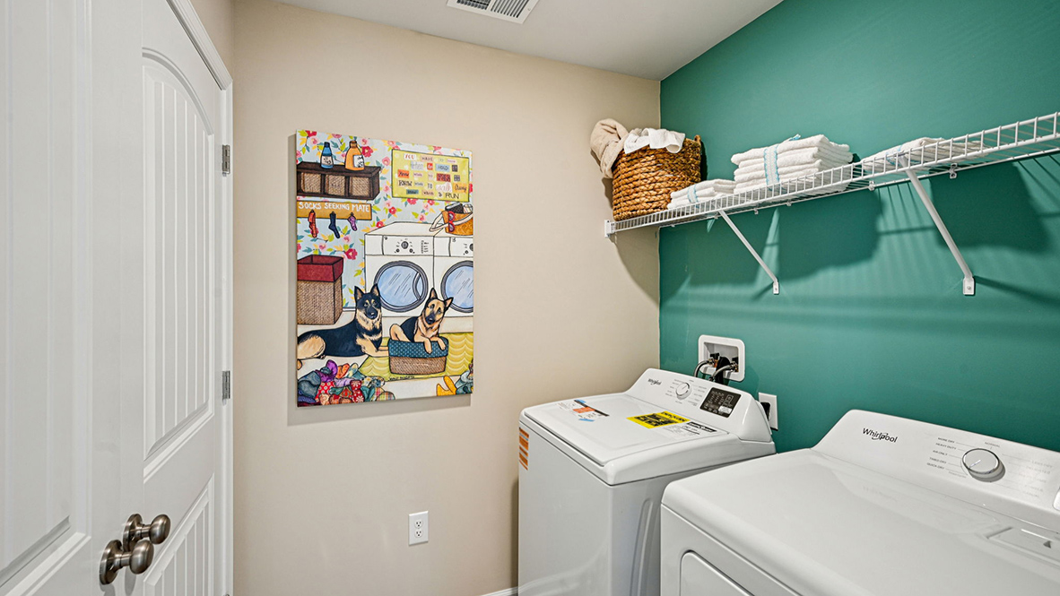 The laundry room includes a washer and dryer.