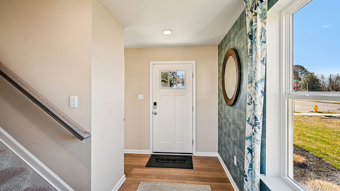A welcoming foyer with a coat closet greets you as you enter this two-story home.