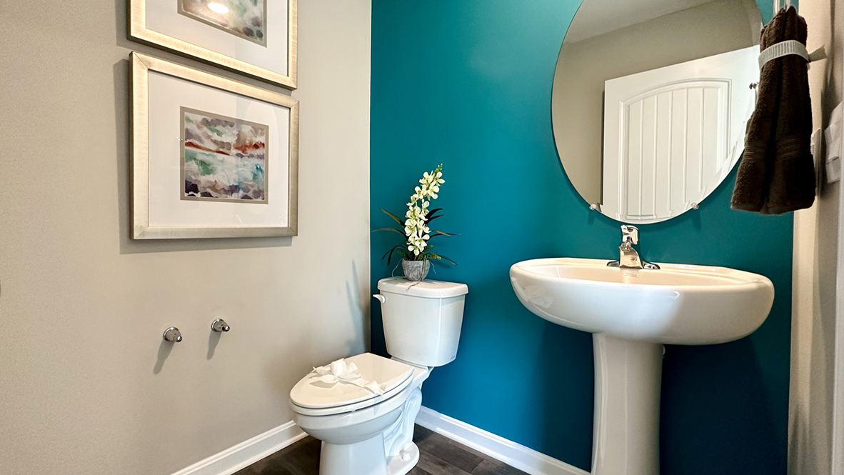 The convenient powder room is located near the one-car garage and coat closet.