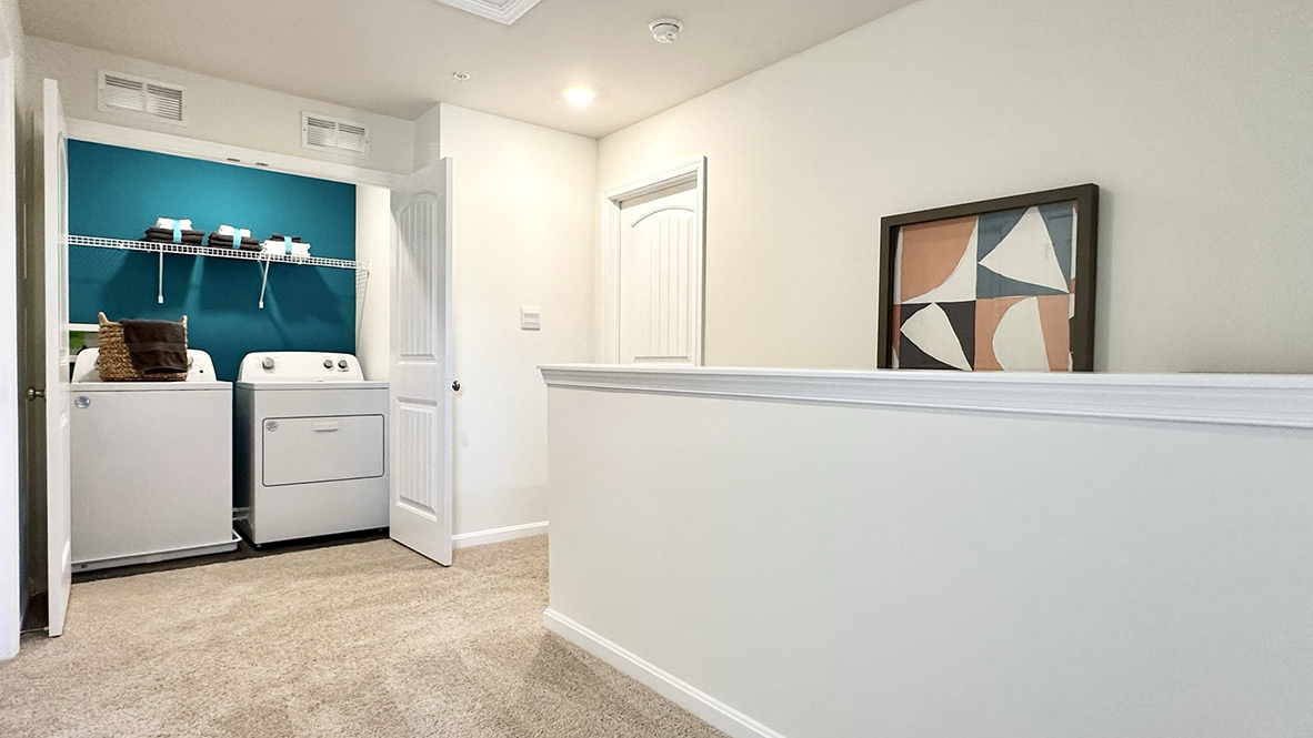 The convenient upstairs laundry closet comes complete with a full-size washer and dryer.
