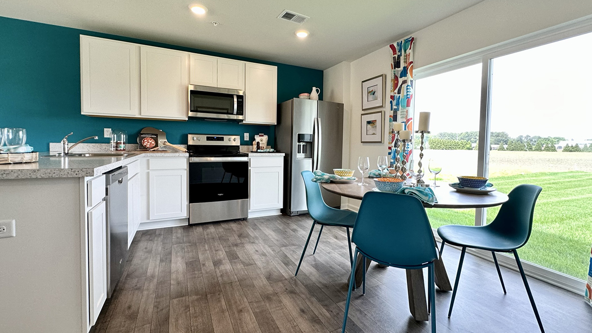 The functional kitchen features an L-shaped counter with a sliding glass door for easy access to the backyard.