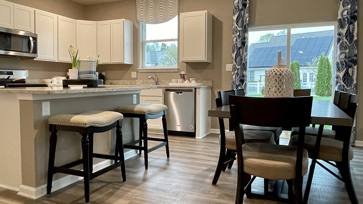 The open-concept kitchen leads into the dining area.