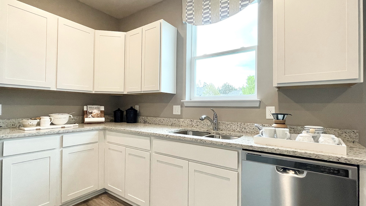 The spacious kitchen boasts an abundance of beautiful cabinetry.