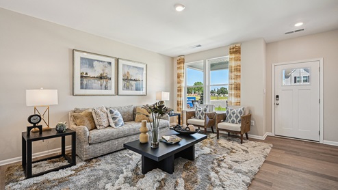 Upon entering through the inviting front porch, you’re welcomed into a bright and expansive great room.
