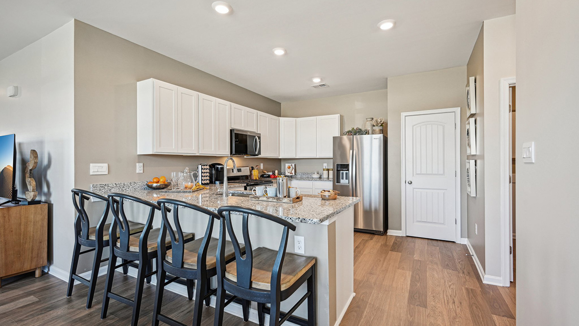 The heart of the home is the well-equipped kitchen, complete with elegant cabinetry.