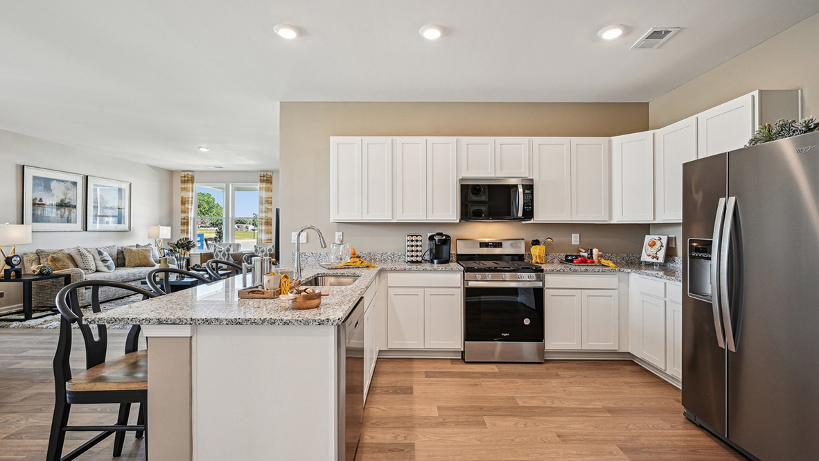 The heart of the home is the well-equipped kitchen, complete with granite countertops.