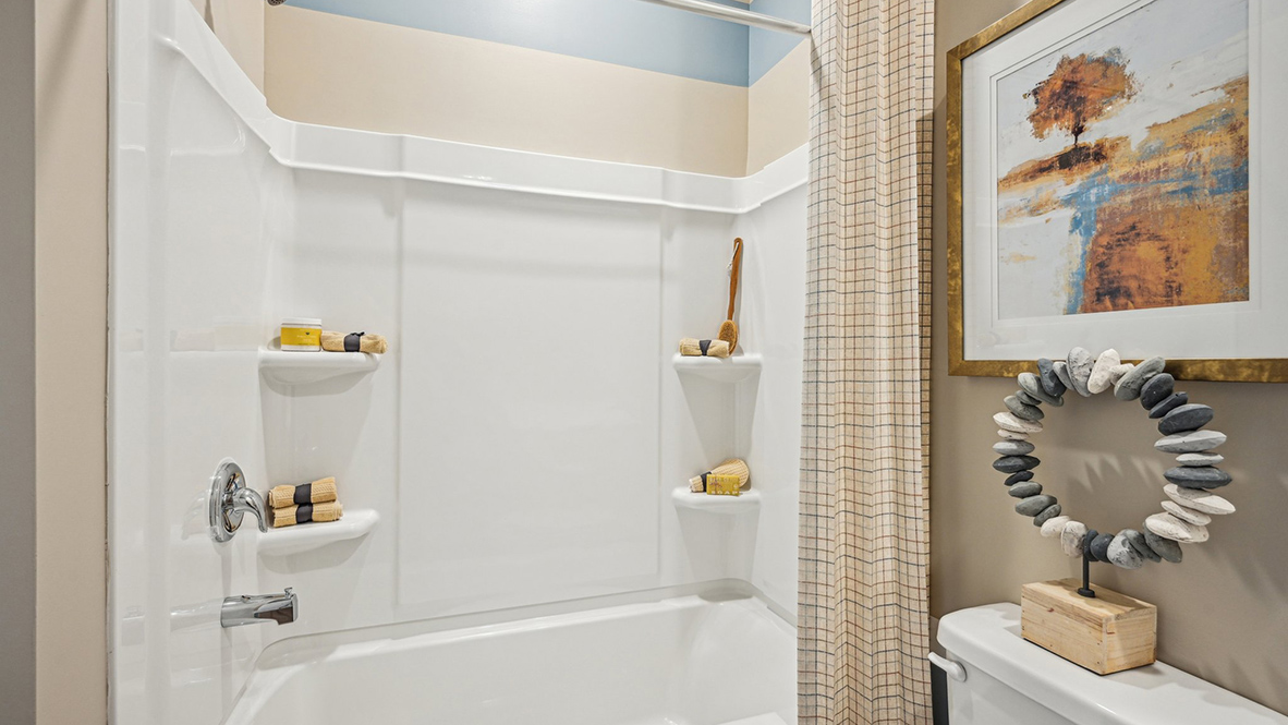 There is a full guest bathroom, located near the third bedroom at the rear of the home.