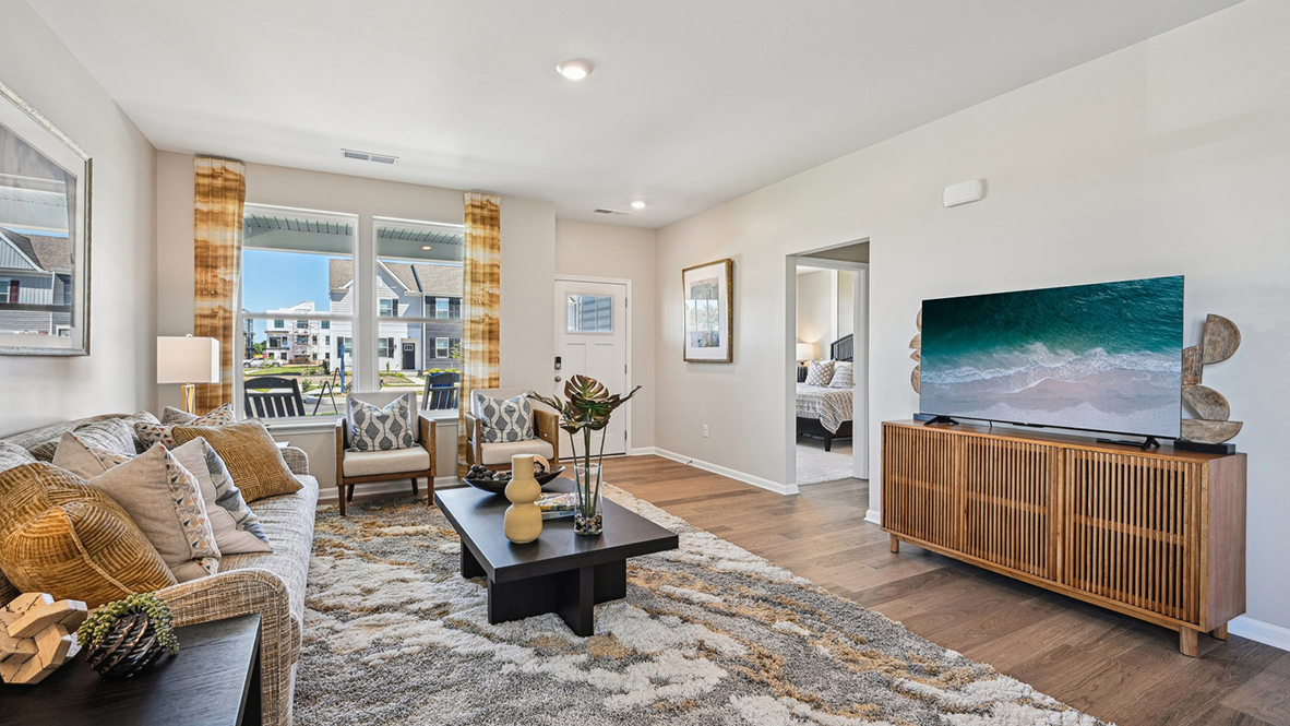 Upon entering through the inviting front porch, you’re welcomed into a bright and expansive great room.