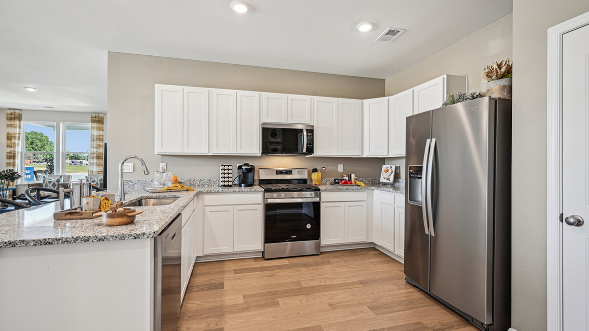 The heart of the home is the well-equipped kitchen, complete with stainless steel appliances.