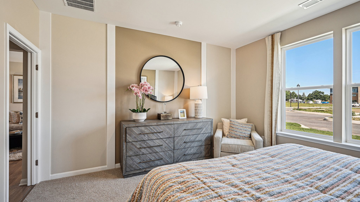 The private owner’s suite, conveniently located near the front of the home, offers a serene retreat.