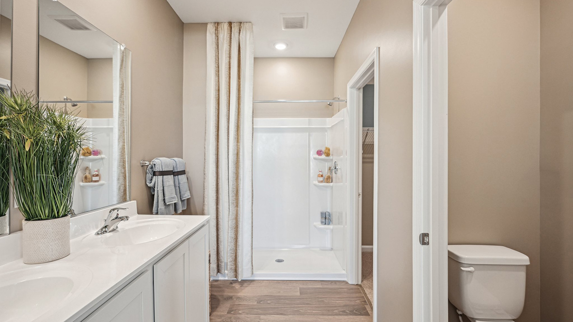 The owner's suite boasts a sizable en suite bathroom with a separate toilet closet.