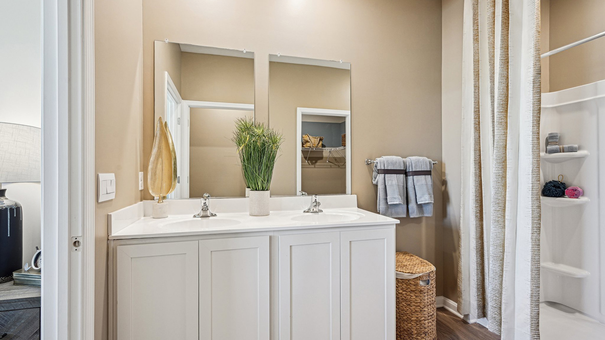 The owner's suite boasts a sizable en suite bathroom with a double-bowl vanity.