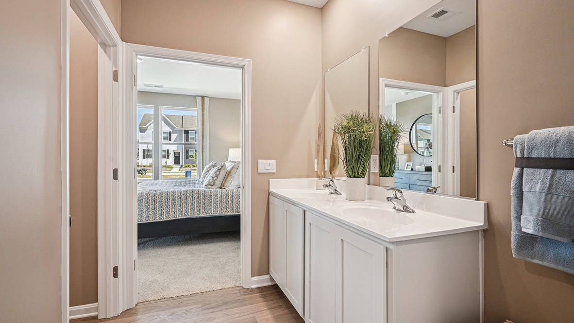 The owner's suite boasts a sizable en suite bathroom with a double-bowl vanity.